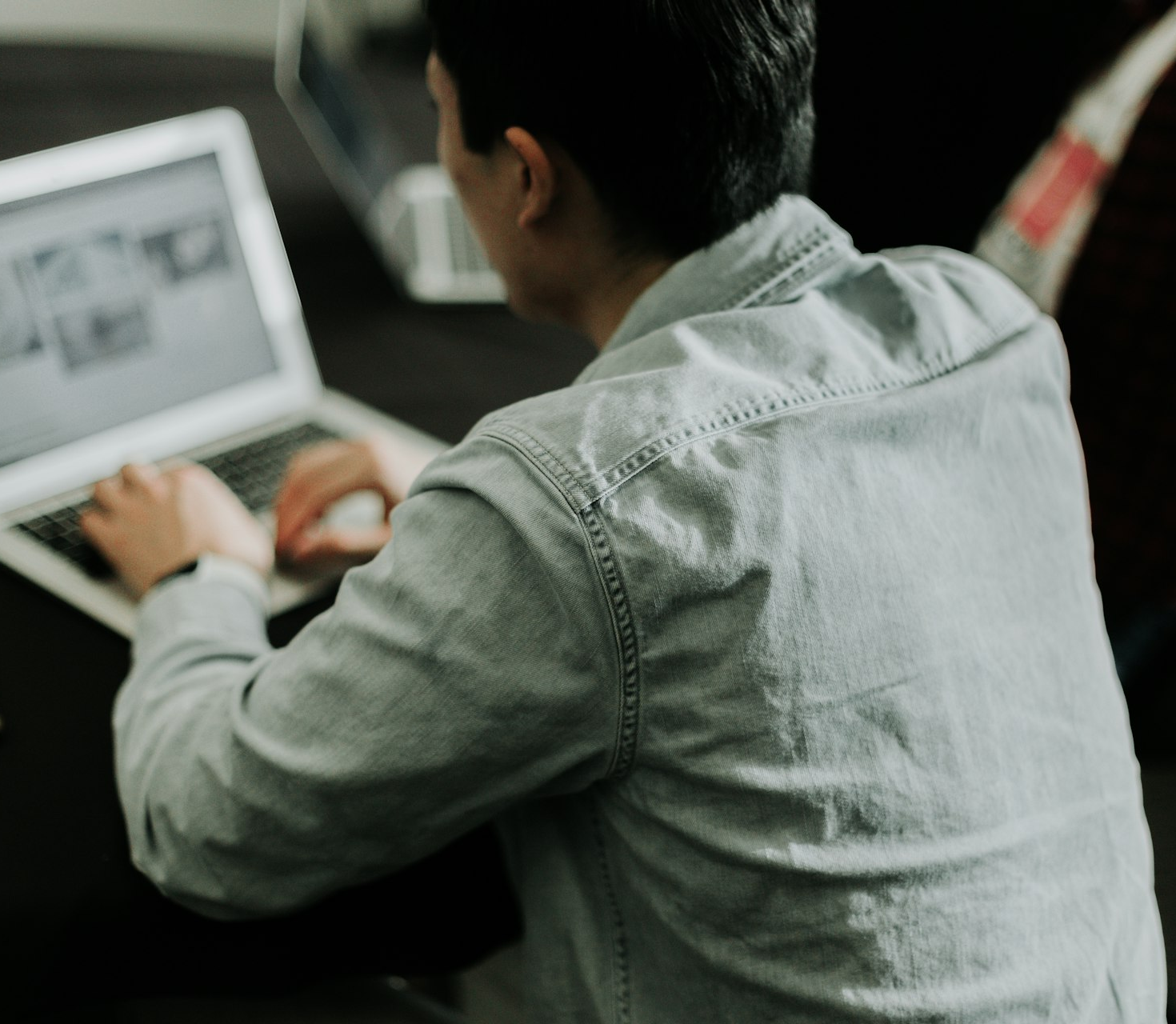a man sitting in front of a laptop computer